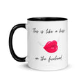 White glossy 11 oz ceramic mug with bold black rim, handle, and interior featuring original poetry reading 'This is like a kiss on the forehead' in elegant script alongside a winged red lips illustration — a romantic gift for her by Syndicated Passion