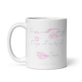 A white ceramic coffee mug with a pink lip print and cursive text that reads 'There's a warmth in your eyes that lingers with me long after the moment passes', with 'Syndicated Passion' printed at the bottom.