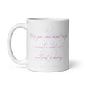 A white ceramic mug featuring a light blue line art illustration of a woman and pink cursive text that reads 'Wrap your arms around me for a moment, a mood, and a bit of knowing' with 'Syndicated Passion' printed below.