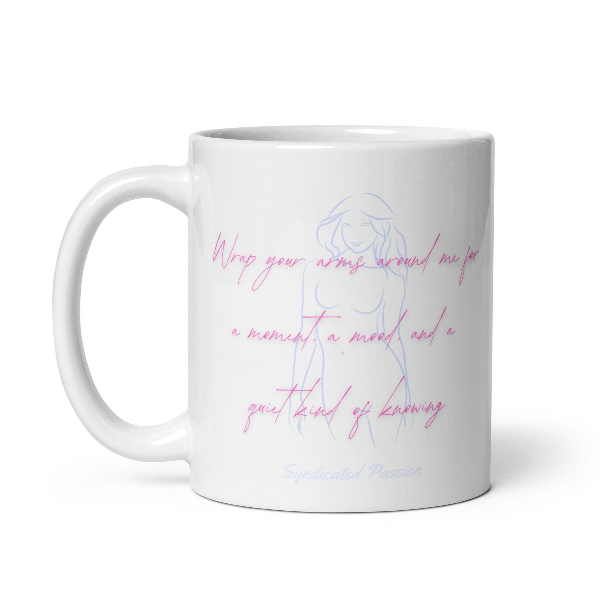 A white ceramic mug featuring a light blue line art illustration of a woman and pink cursive text that reads 'Wrap your arms around me for a moment, a mood, and a bit of knowing' with 'Syndicated Passion' printed below.