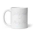 White glossy 11 oz ceramic mug with original poetry reading "Guided by Angels and Moved by Music" in elegant script alongside a soft blue ethereal angel illustration — a spiritual gift for music lovers and dreamers by Syndicated Passion®