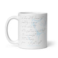 White ceramic 11 oz coffee mug featuring delicate handwritten poetry in pencil color over a soft blue watercolor portrait, Syndicated Passion.⠋