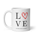 White ceramic 11 oz coffee mug with black “L” and “VE” lettering around a hand-drawn red heart to spell “LOVE,” Syndicated Passion.